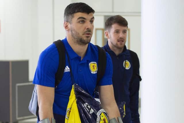 Callum Paterson comes home on crutches from Scotland duty. Picture: SNS