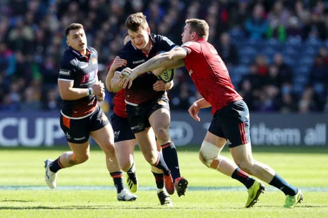 Edinburgh's Chris Dean is tackled by Keith Earis of Munster. Picture: Getty