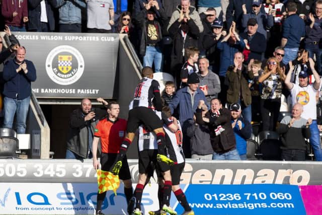 St Mirren' players celebrate Brad Lyons' goal in front of the home support. Picture: SNS