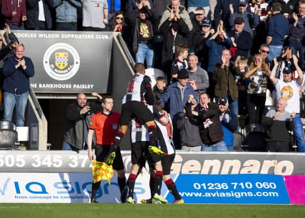 St Mirren' players celebrate Brad Lyons' goal in front of the home support. Picture: SNS