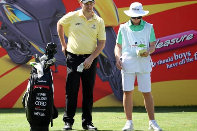 Stephen Gallacher and son and caddie Jack talk tactics during the final round at DLF Golf & Country Club. Picture: Getty Images