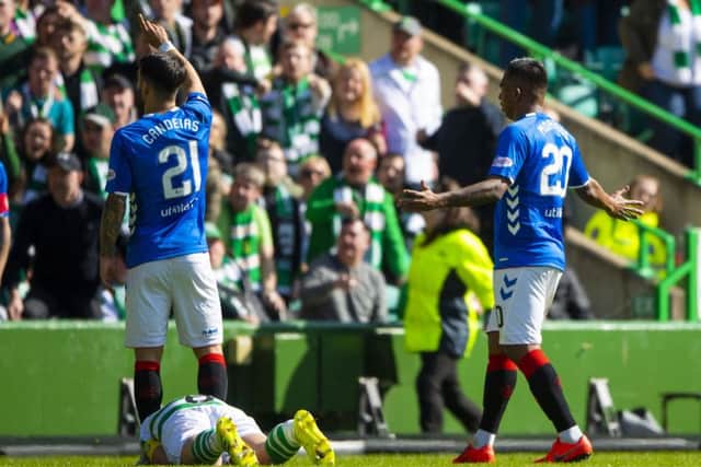 Rangers' Alfredo Morelos protests his innocence as Celtic captain Scott Brown lies on the turf. Picture: SNS