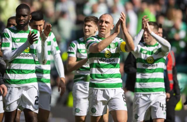 The victorious Celtic players applaud their fans at full time. Picture: SNS