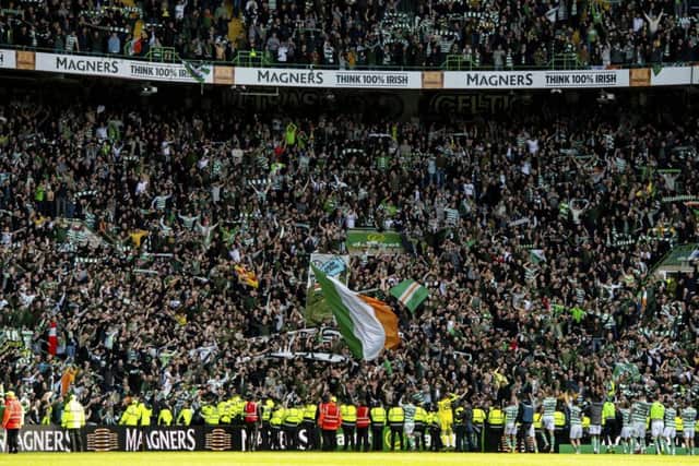 Celtic's players celebrate with fans at full time. Picture SNS