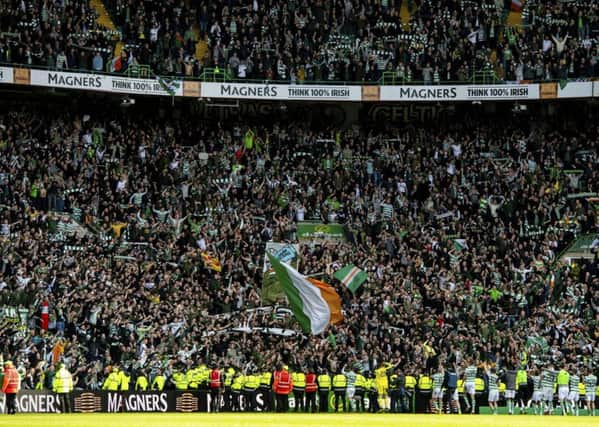 Celtic's players celebrate with fans at full time. Picture SNS