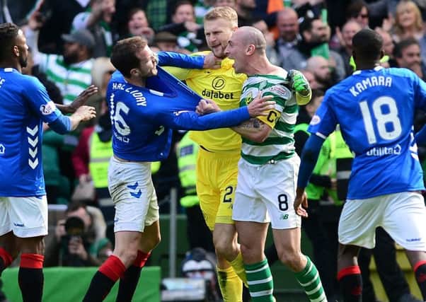 Scott Brown and Andy Halliday come to blows at full-time following Celtic's 2-1 win over Rangers. Picture: Mark Runnacles/Getty Images