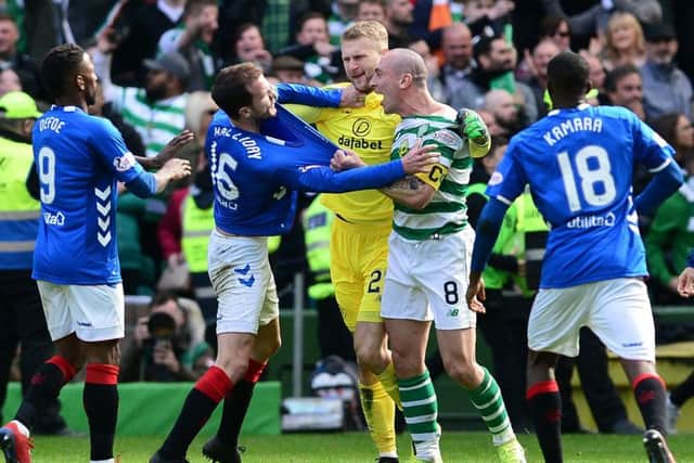 Scott Brown clashes with Rangers' Andy Halliday. Picture: Mark Runnacles/Getty