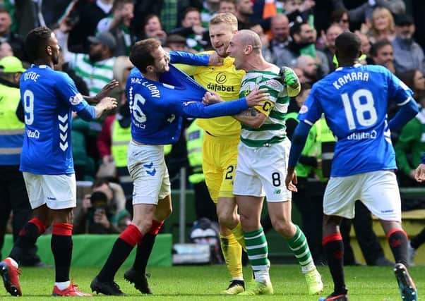 Scott Brown clashes with Rangers' Andy Halliday. Picture: Mark Runnacles/Getty