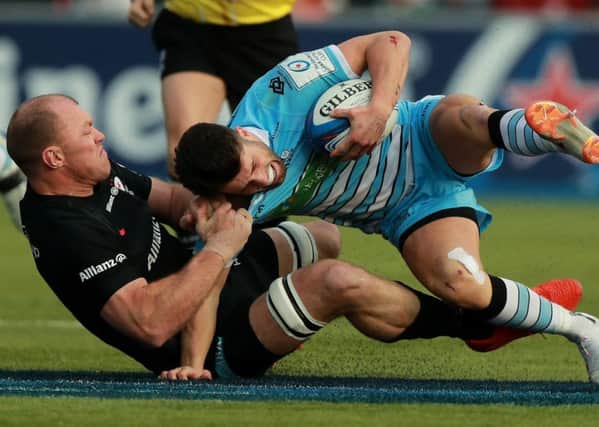 Glasgow No 10 Adam Hastings is tackled by Saracens Schalk Burger. Picture: SNS.