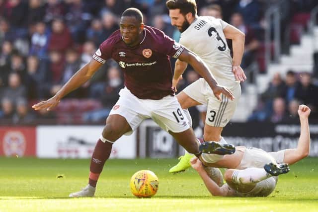 Uche Ikpeazu holds off Aberdeen captain Graeme Shinnie during an impressive performance at Tynecastle on Saturday. Picture: SNS.