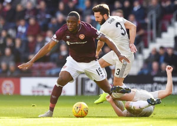 Uche Ikpeazu holds off Aberdeen captain Graeme Shinnie during an impressive performance at Tynecastle on Saturday. Picture: SNS.