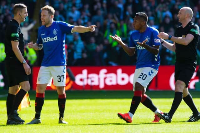 Alfredo Morelos argues against red card. Picture: SNS
