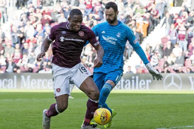 Uche Ikpeazu was booked despite being caught by Aberdeen goalkeeper Joe Lewis in the box