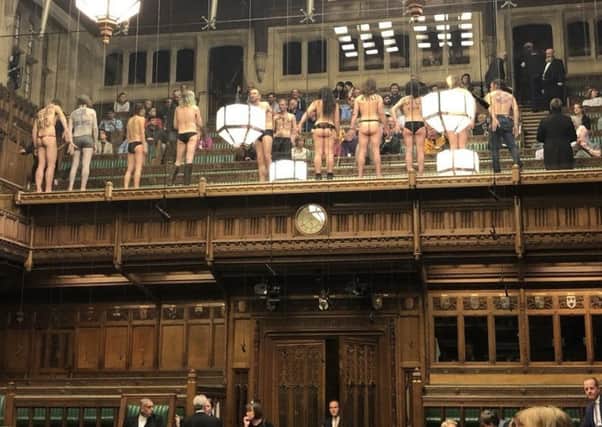 More than 10 people in the public gallery with messages written on their bodies joined the protest. Picture: PA