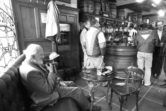 An old man smoking his pipe in the traditional pub Ryrie's at Haymarket in Edinburgh, March 1993.