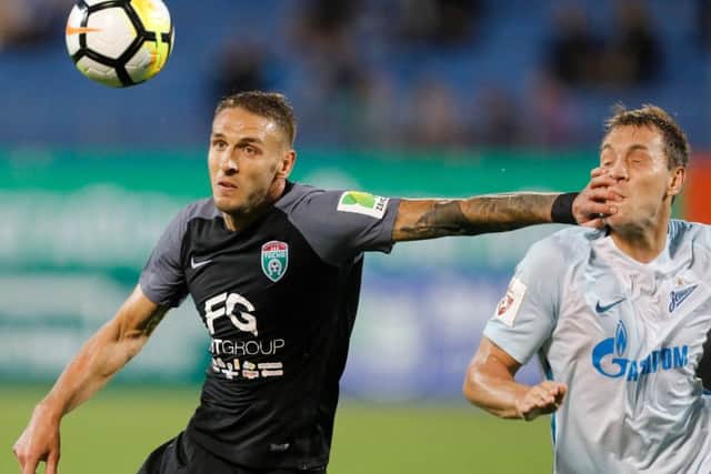 Rade Dugalic (left) fends off a challenge from forward Artyom Dzyuba during a match between Zenit and Tosno in July 2017. Picture: Getty Images