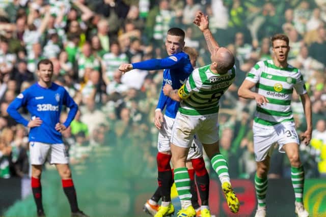 Ryan Kent clashes with Scott Brown during the Old Firm match. Picture: SNS Group