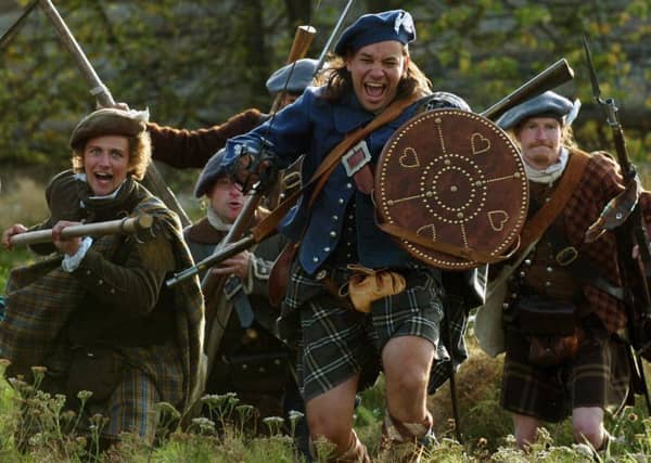 Jacobite re-enacters display a charge ahead of staging a battle in Prestonpans