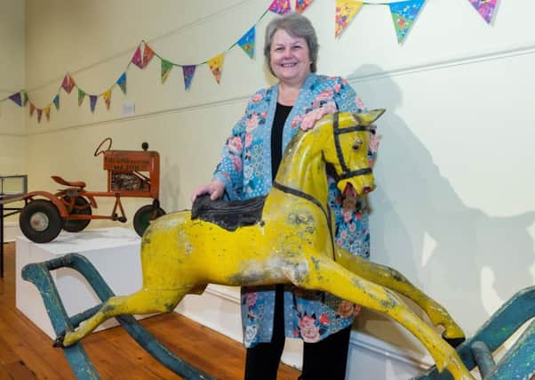 Councillor Anne Stirling with a  hand-painted wooden rocking horse dates from around 1850 and was donated to Aberdeenshire Council Museums