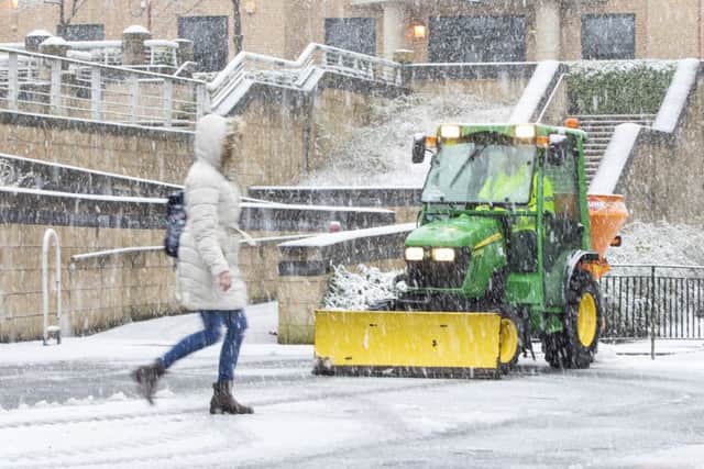A small snow plough clears paths in Livingston