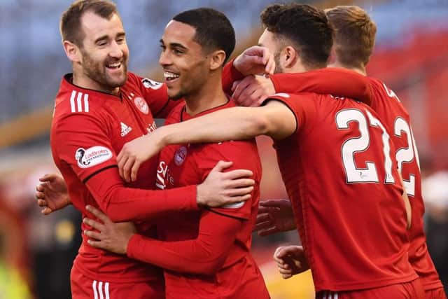 Max Lowe is mobbed by his team-mates after scoring the opener. Picture: SNS Group