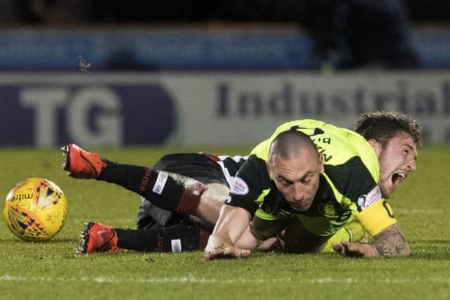 Scott Brown challenges St Mirren's Jim Kellermann, with the latter feeling the full force of the Celtic skipper. Picture: SNS Group