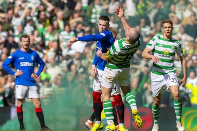 Rangers' Ryan Kent clashes with Celtic's Scott Brown. Picture: SNS/Alan Harvey