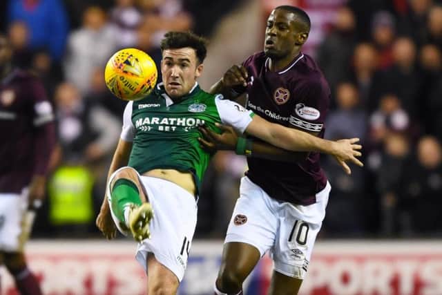 Hibs' Stevie Mallan in action with Hearts midfielder Arnaud Djoum. Picture: SNS Group