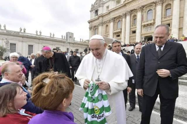 Pope Francis was handed a Celtic top by members of the crowd - believed to be Scottish tourists. Picture: Sancta Familia Media