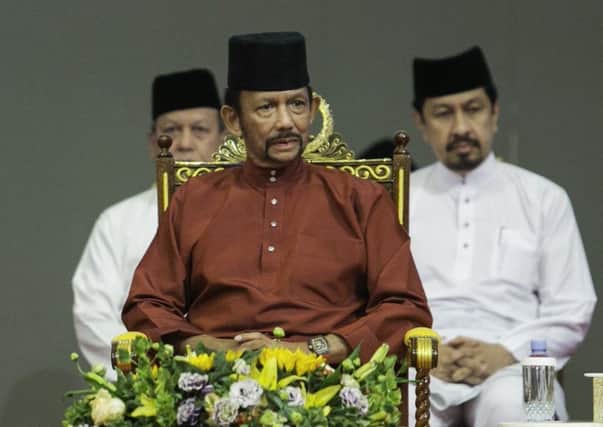 Brunei's Sultan Hassanal Bolkiah, centre, attends an event in Bandar Seri Begawan. Picture: AFP/Getty Images