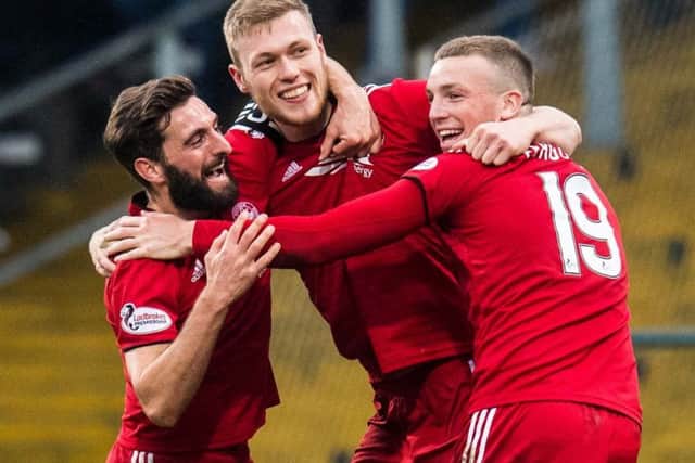 Sam Cosgrove, centre, celebrates his second goal with Aberdeen captain Graeme Shinnie and Lewis Ferguson. Picture: Ross Parker/SNS