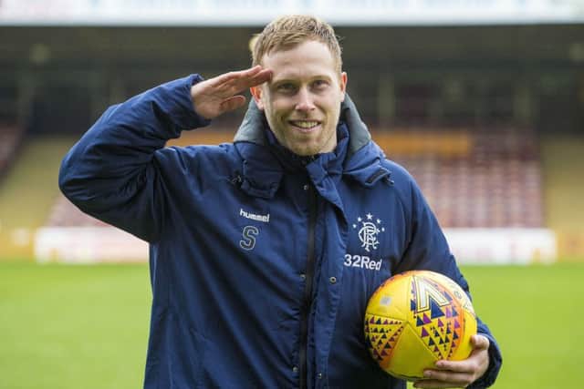 Scott Arfield clutches the match ball after netting all three goals in Rangers' 3-0 win over Motherwell. Picture: SNS