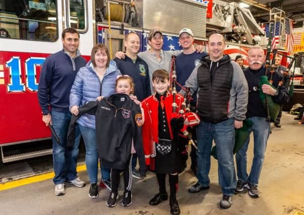 Piper Josh Bruce with his personalised jacket from the New York Fire Department. Picture: New York Tartan Week/PA