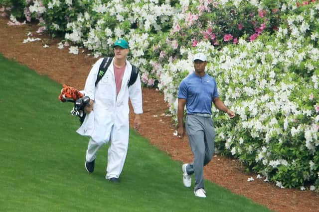 Tiger Woods walks with his caddie Joe LaCava on the 13th hole during a practice round at Augusta. Picture: Andrew Redington/Getty Images