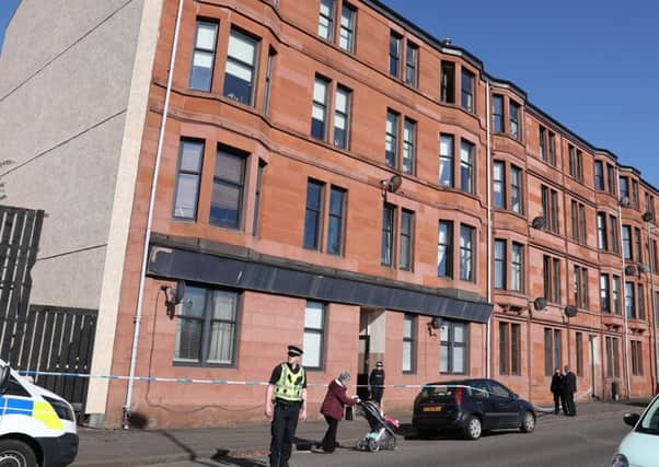 Police outside a block of flats on Dumbarton Road. Picture: Andrew Milligan/PA Wire