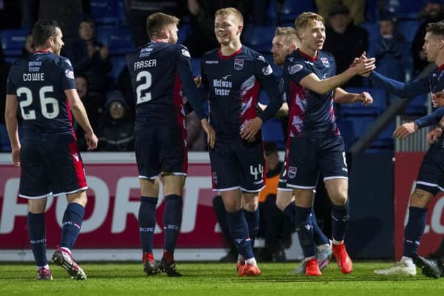Ross County's Tom Grivosti, centre, celebrates with his team-mates after scoring the winning goal. Picture: Craig Foy/SNS
