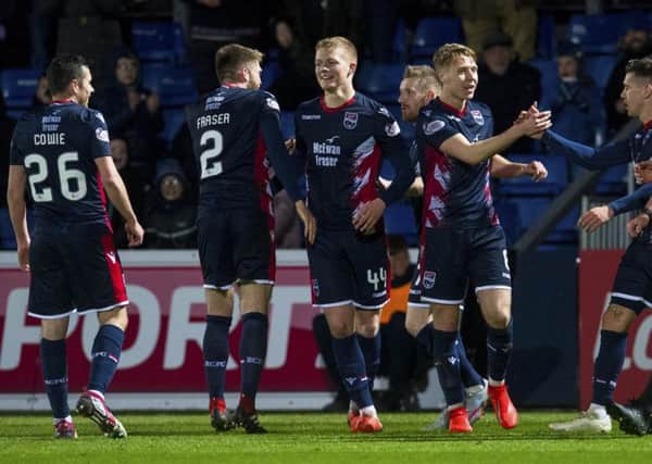 Ross County's Tom Grivosti, centre, celebrates with his team-mates after scoring the winning goal. Picture: Craig Foy/SNS