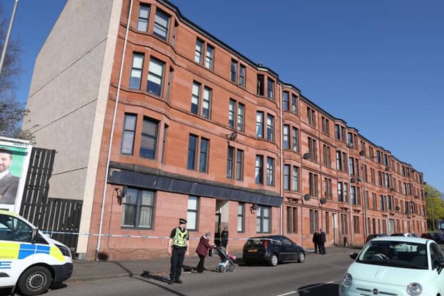 Police outside a block of flats on Dumbarton Road in Clydebank where a two-year-old girl is in hospital after falling from a window. Picture: Andrew Milligan/PA Wire