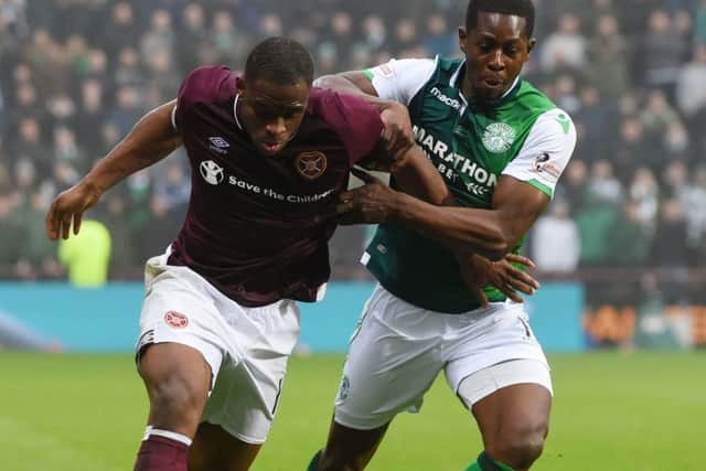 Hibernian's Marvin Bartley, right, with
Hearts' Uche Ikpeazu. Picture: SNS