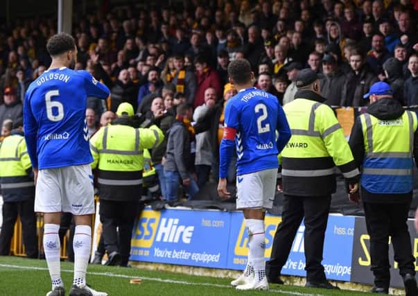 Rangers captain James Tavernier spots an object thrown from the Motherwell fans as he goes to take a throw-in. Picture: SNS