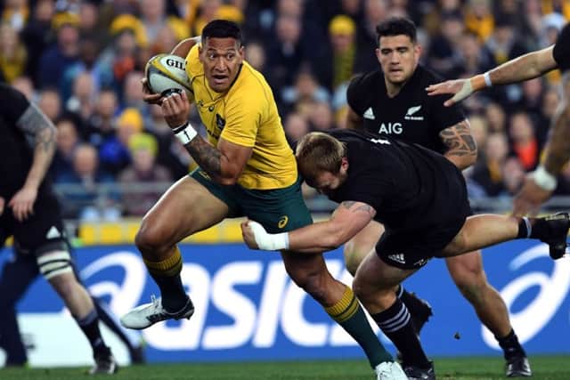 Australia full-back Israel Folau, left, is set to have his contract terminated over his latest anti-gay rant. Picture: William West/AFP/Getty Images