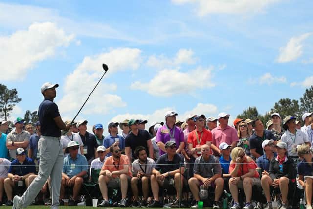 All eyes on Tiger Woods tee shot at the eighth during the opening round at Augusta.