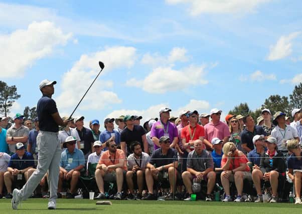 All eyes on Tiger Woods tee shot at the eighth during the opening round at Augusta.