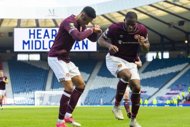 Hearts' Sean Clare dances with Uche Ikpeazu after the third goal. Pic: SNS/Craig Foy