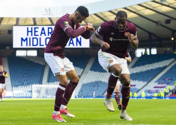 Hearts' Sean Clare dances with Uche Ikpeazu after the third goal. Pic: SNS/Craig Foy