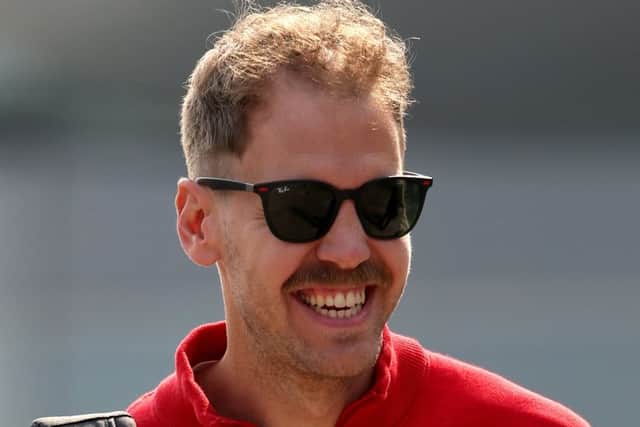Sebastian Vettel walks into the paddock before practice for the F1 Grand Prix of China. Pic: Charles Coates/Getty