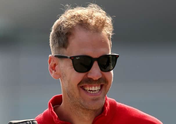 Sebastian Vettel walks into the paddock before practice for the F1 Grand Prix of China. Pic: Charles Coates/Getty