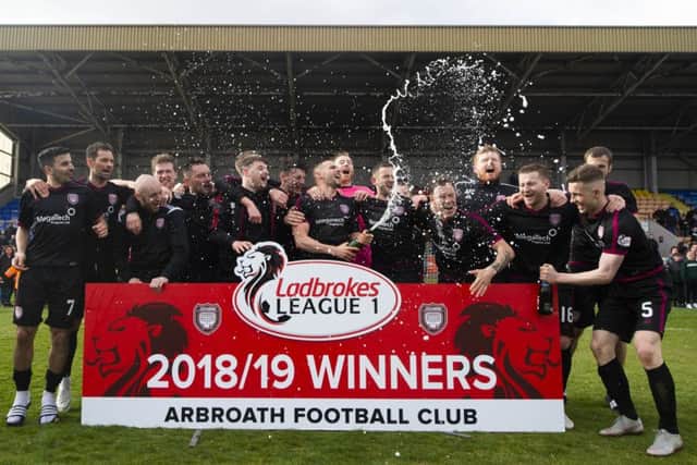 The Arbroath players celebrate promotion to the Ladbrokes Championship. Pic: SNS/Ross MacDonald