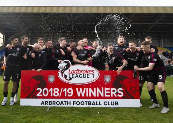 The Arbroath players celebrate promotion to the Ladbrokes Championship. Pic: SNS/Ross MacDonald