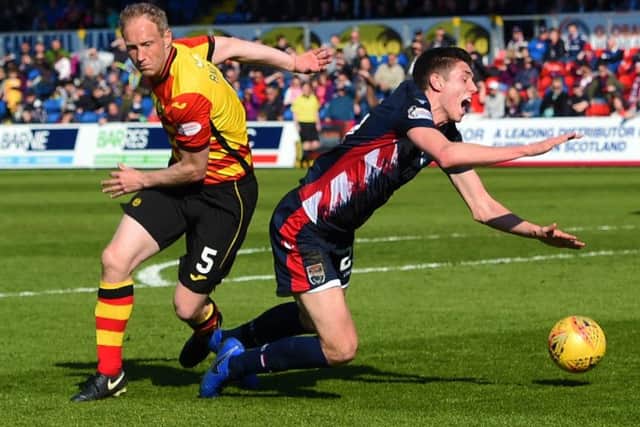 Ross County's Ross Stewart goes down under a challenge from Partick Thistle's Steven Anderson. Pic: SNS/Paul Devlin